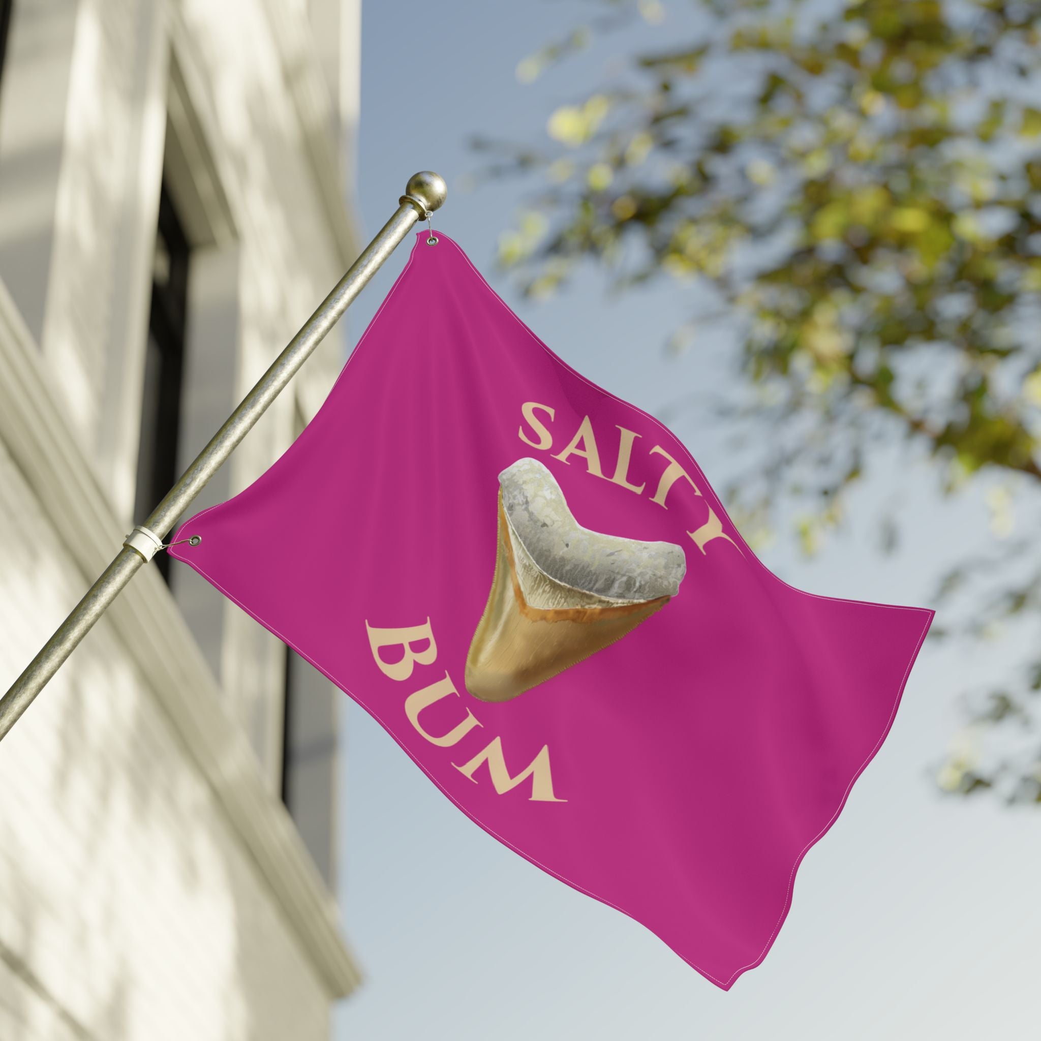 Pink flag with a graphic of a fortune cookie and 'Salty Bum' text, attached to a flagpole outdoors.