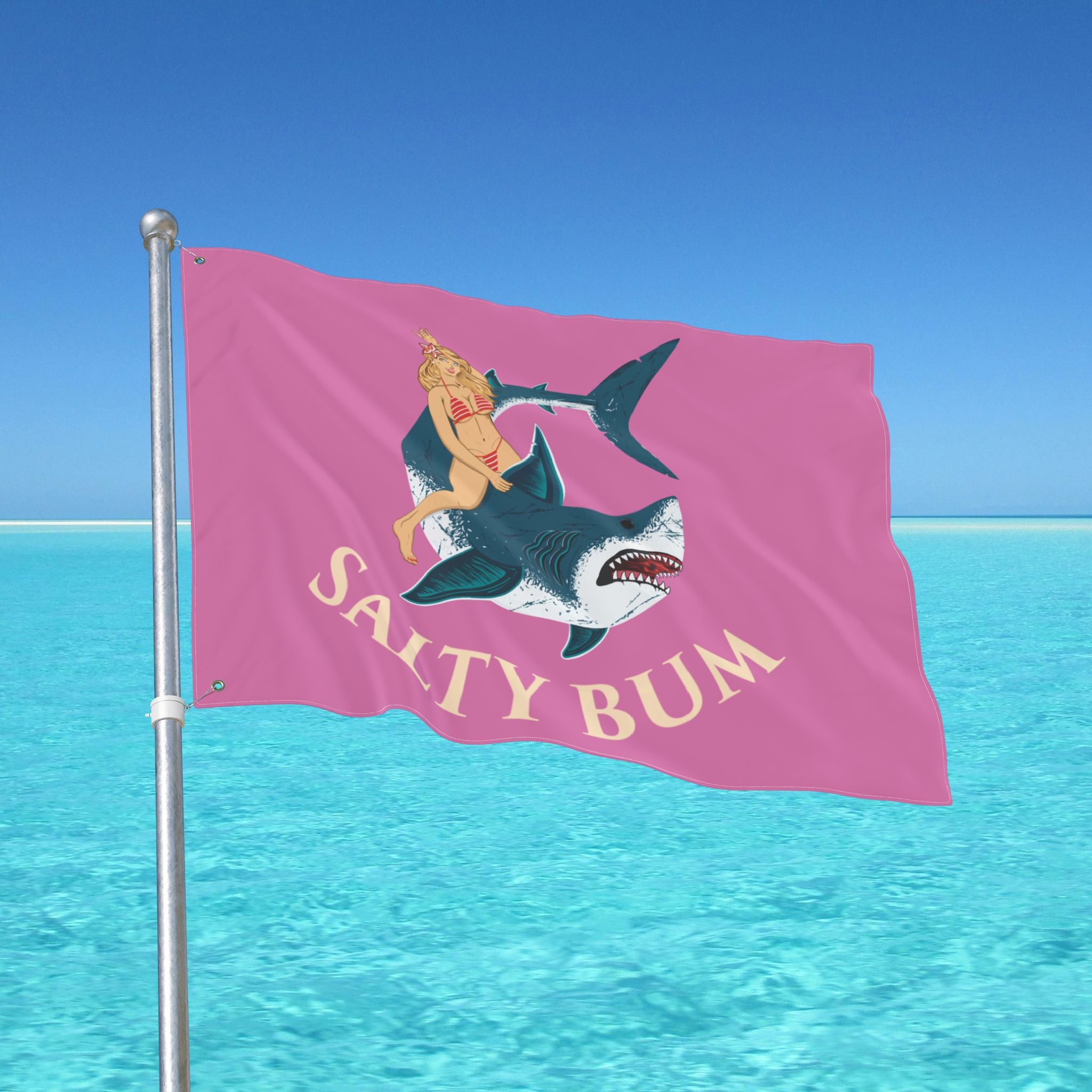 Flag with a shark and bikini-clad figure design against a blue ocean and sky background