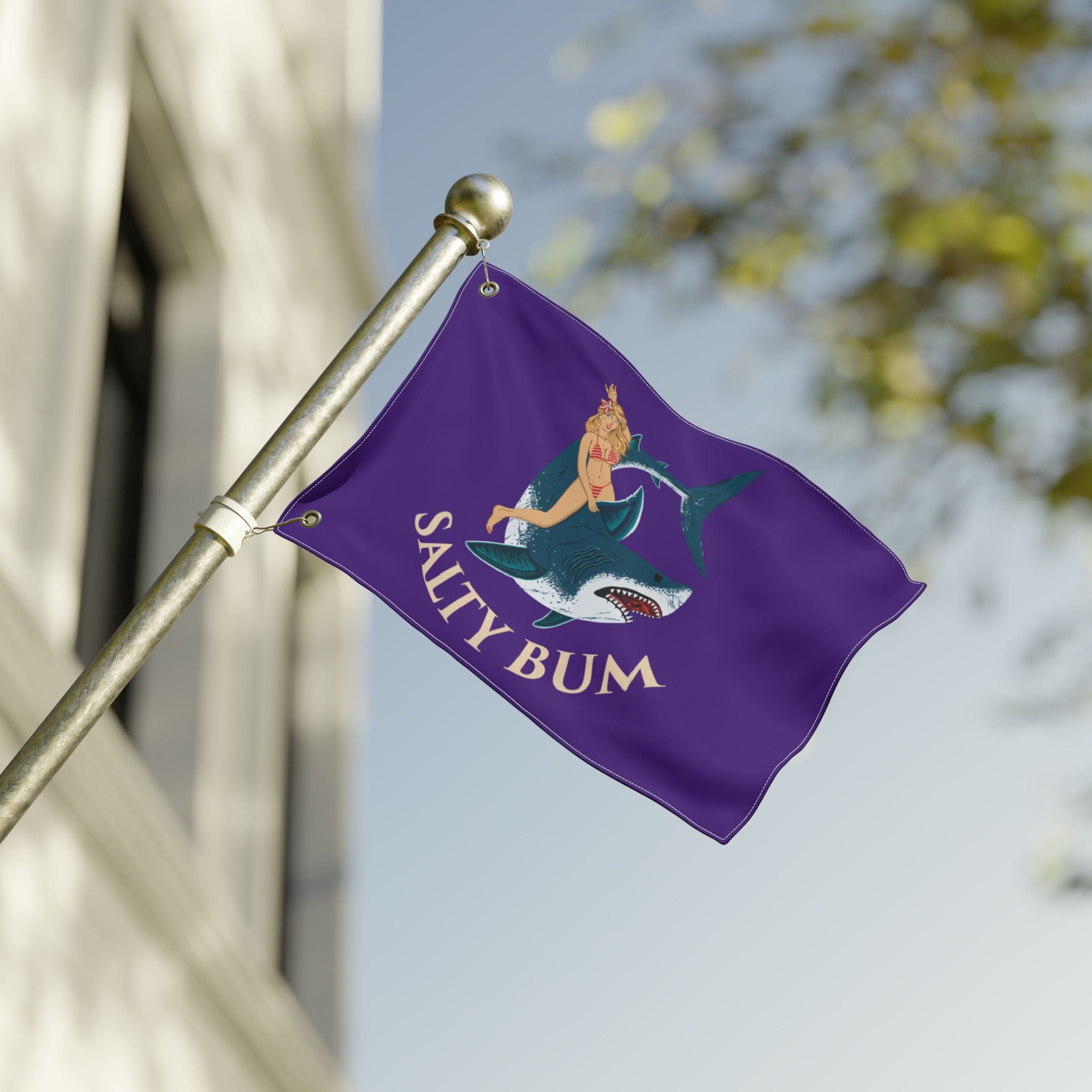 Purple flag with 'Salty Bum' design on a pole against a blurred background