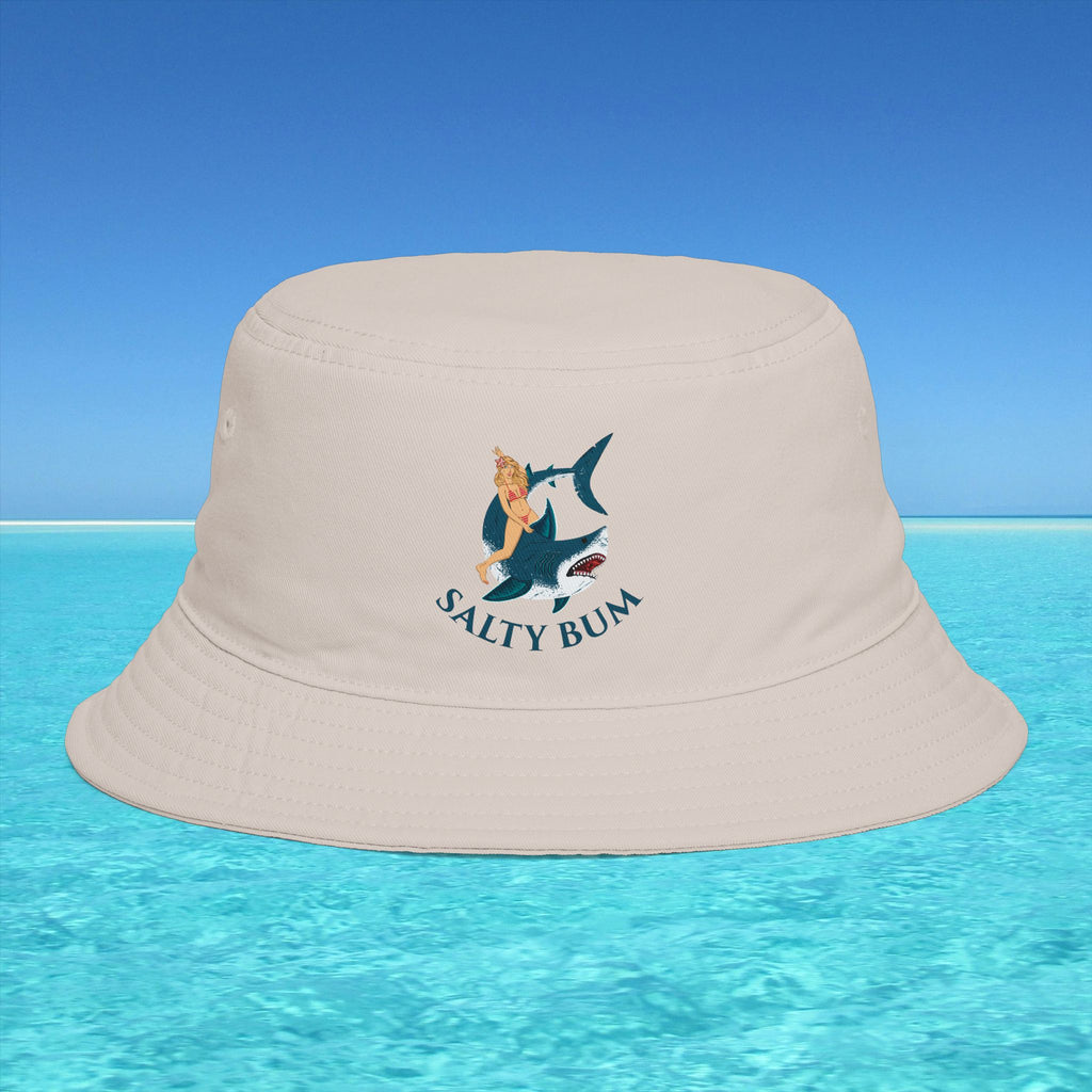 Beige bucket hat with 'Salty Bum' logo on a blue water and sky background