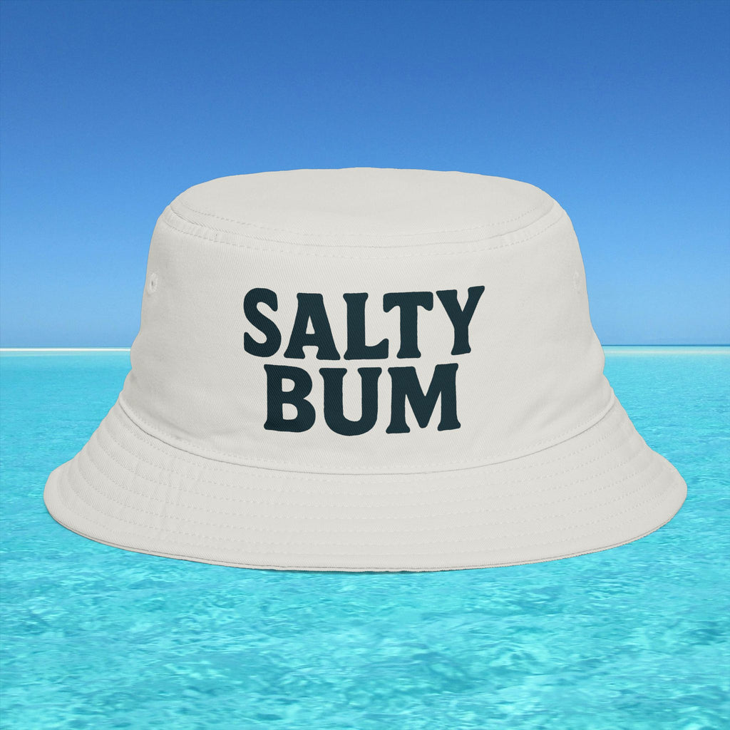 Beige bucket hat with 'Salty Bum' text floating on clear blue water with a blue sky background