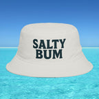 Beige bucket hat with 'Salty Bum' text floating on clear blue water with a blue sky background
