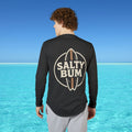 Person wearing a black long-sleeve shirt with 'Salty Bum' logo in a beach setting