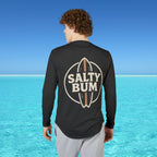 Person wearing a black long-sleeve shirt with 'Salty Bum' logo in a beach setting