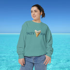 Person wearing a teal sweatshirt with 'Salty Bum' text and ice cream graphic against a blue ocean background
