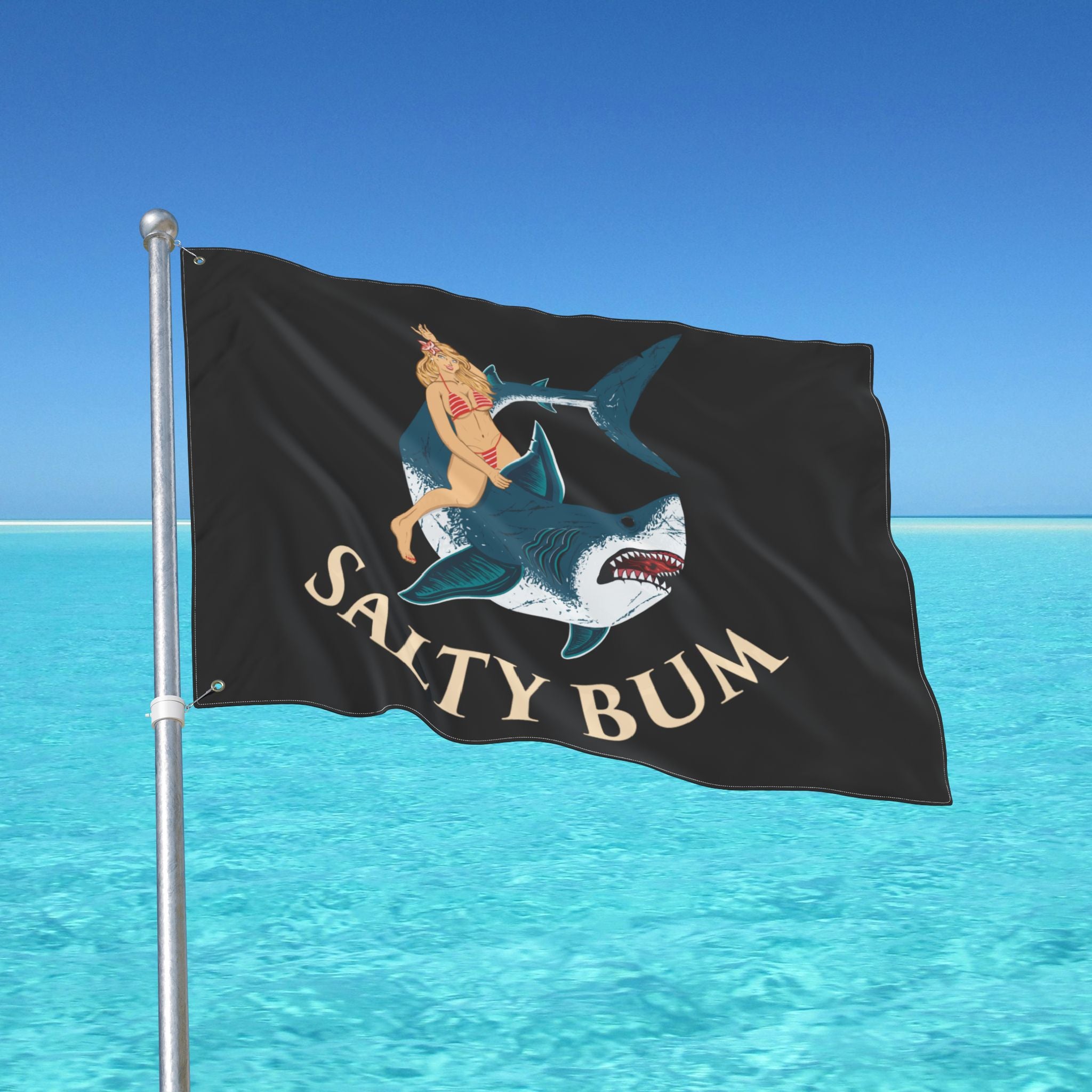 Flag with a shark and bikini-clad figure design against a blue ocean background
