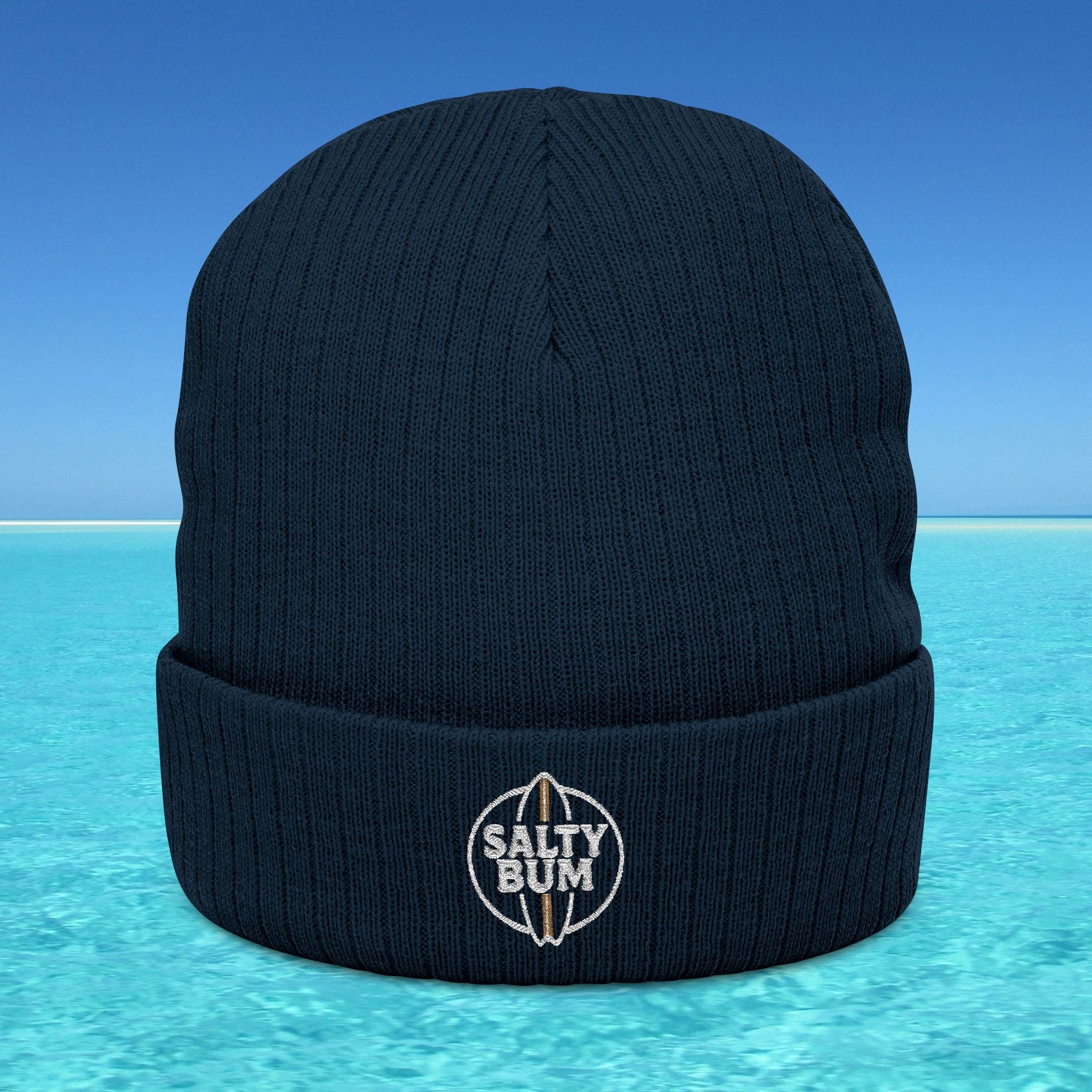 Navy blue beanie with 'Salty Bum' logo on a blue water background