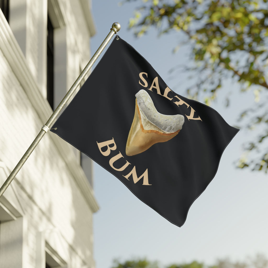 Flag with a shark tooth graphic and 'Salty Bum' text on a building exterior.