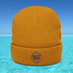 Orange beanie with 'Salty Bum' logo on a blue water and sky background