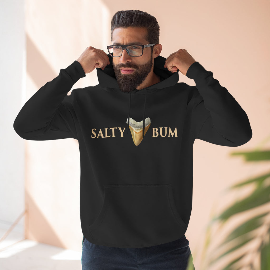 Man wearing a black hoodie with 'Salty Bum' text and graphic indoors.