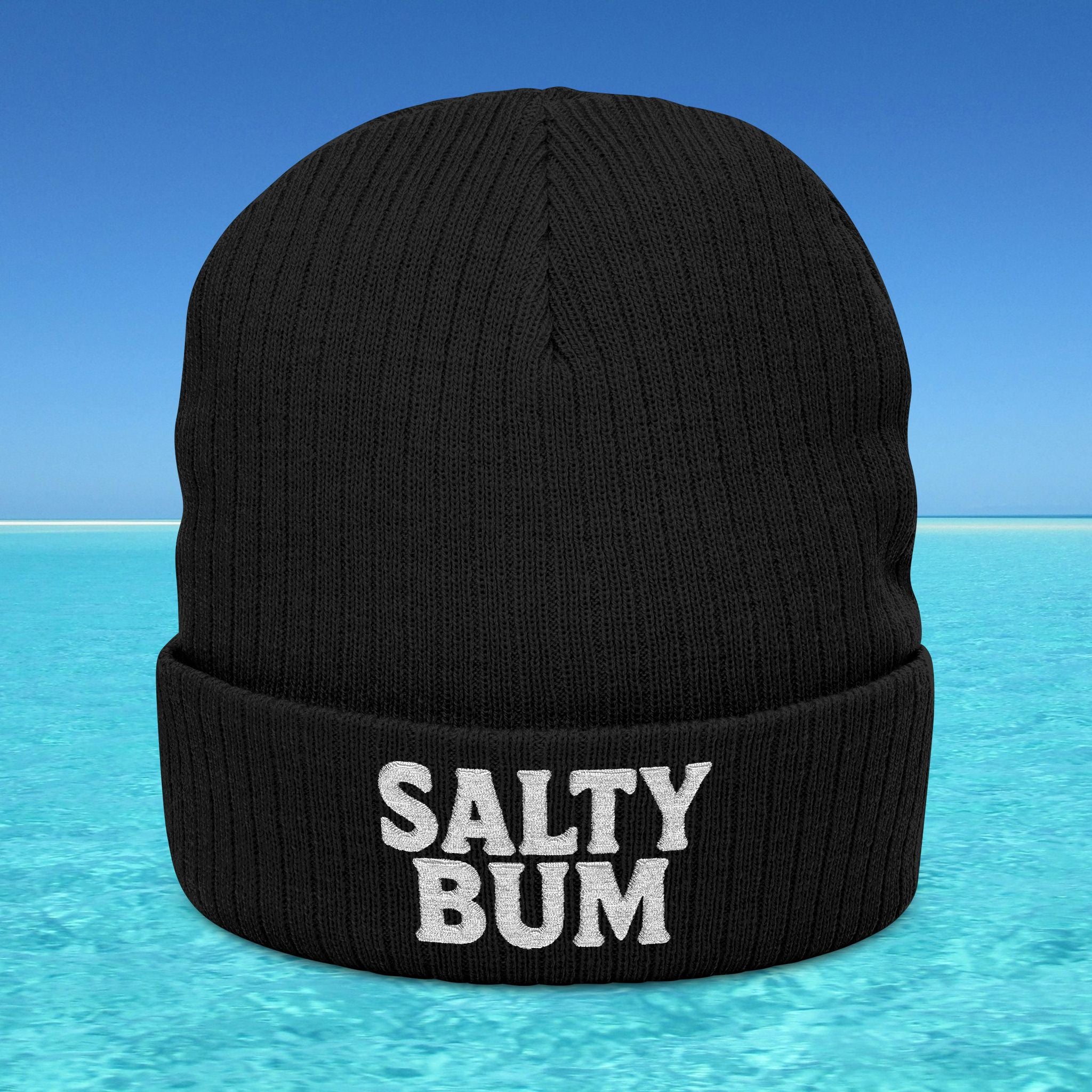 Black beanie with 'Salty Bum' text on a blue water and sky background