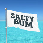 Flag with 'Salty Bum' text against a clear blue sky and ocean background
