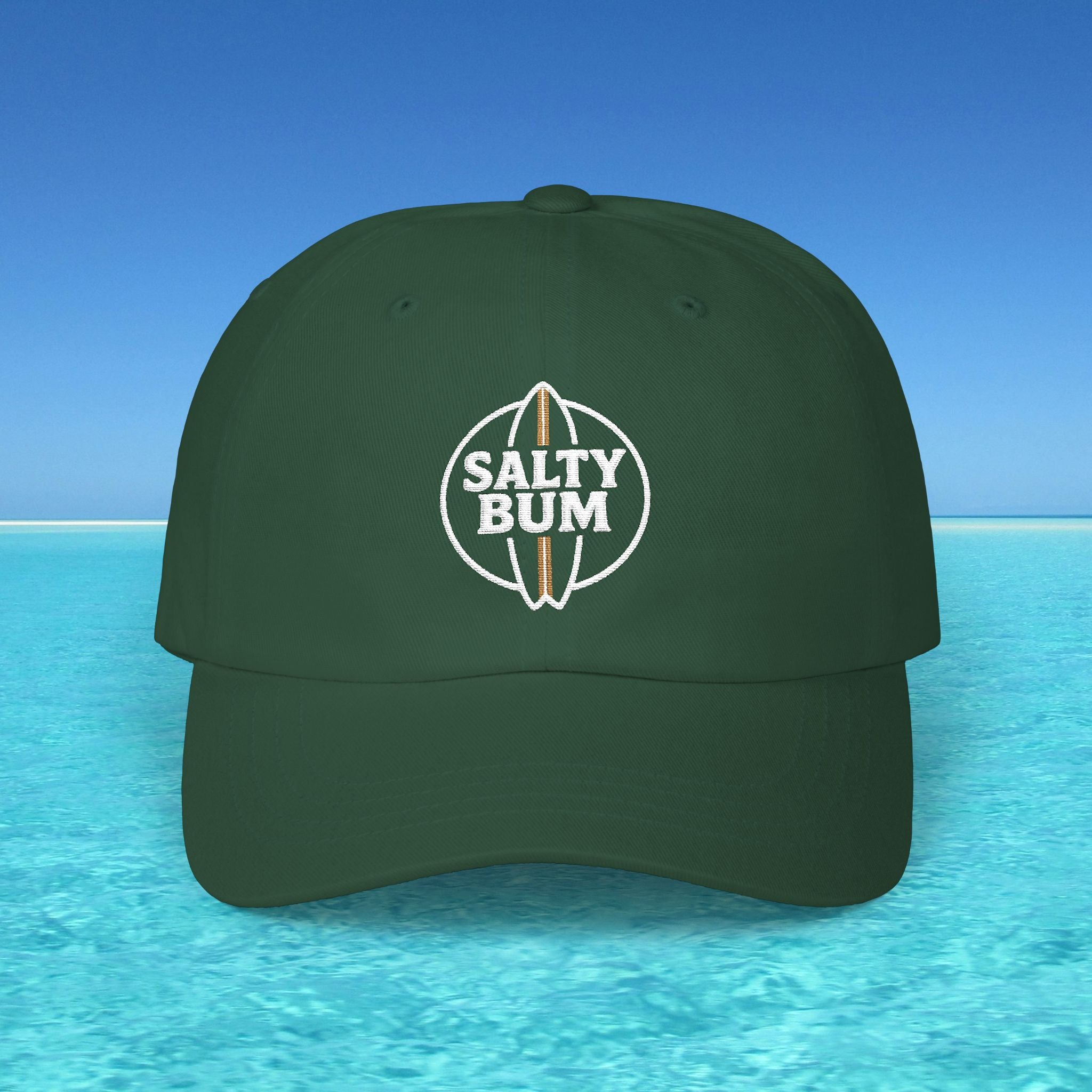 Green cap with 'Salty Bum' logo on a blue water and sky background