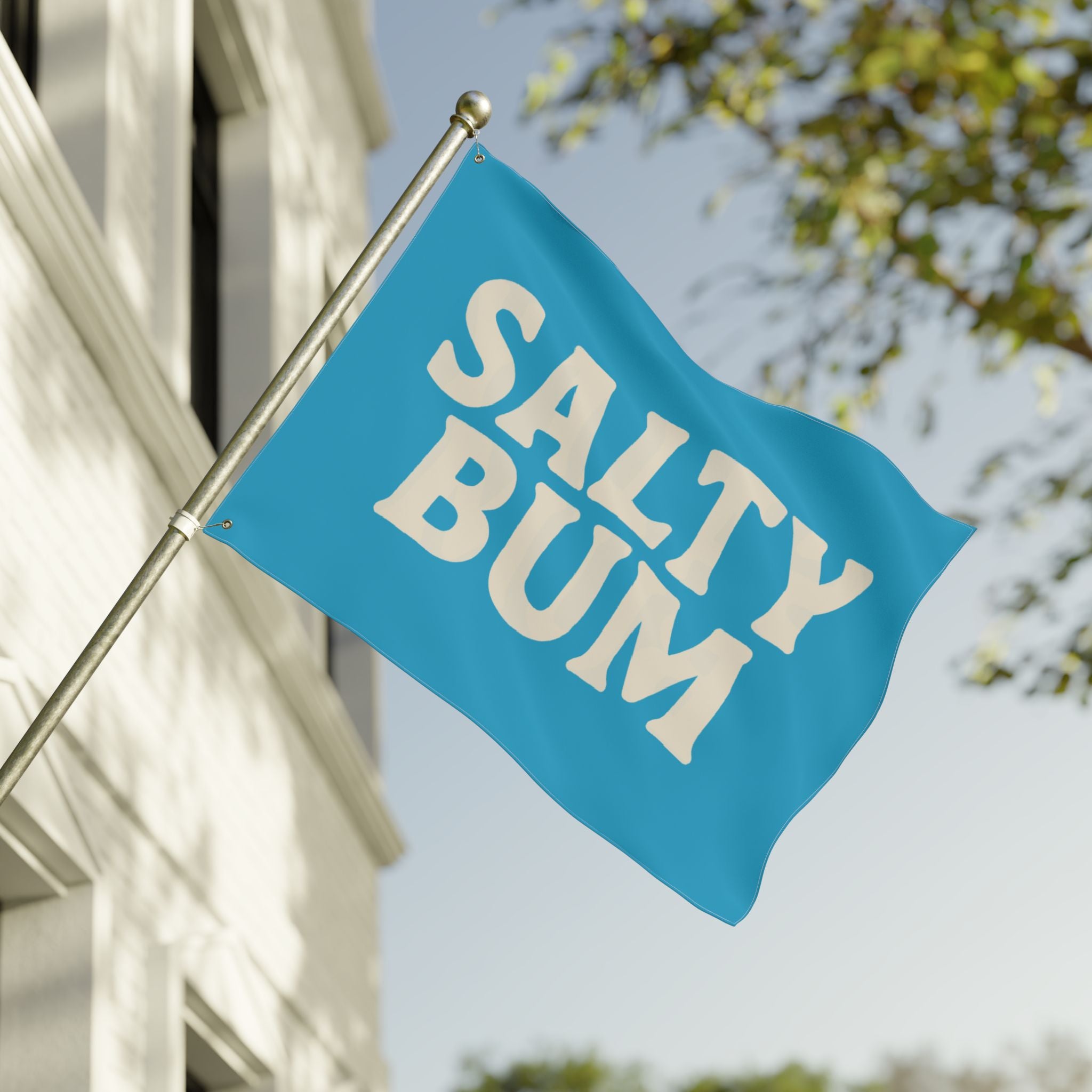 Blue flag with 'Salty Bum' text on a building exterior