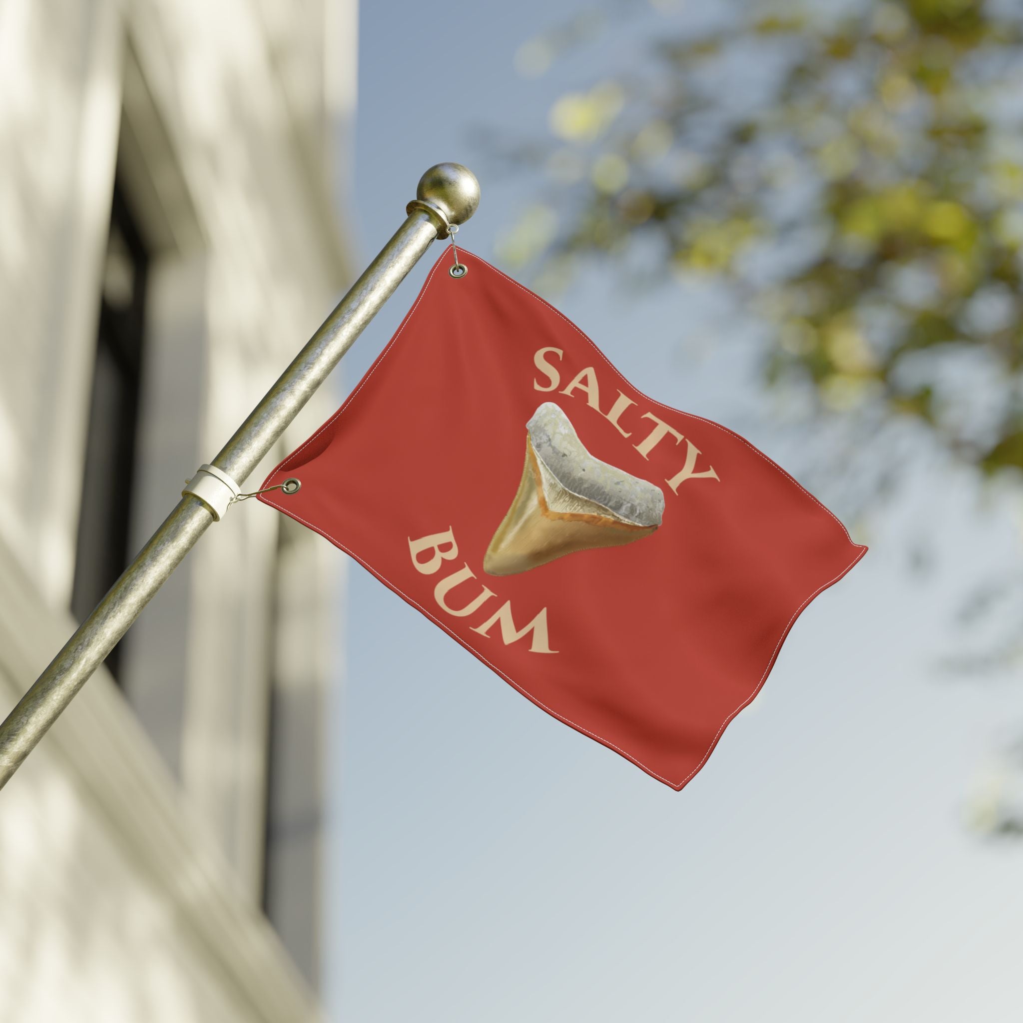 Red flag with 'Salty Bum' text and graphic on a blurred outdoor background