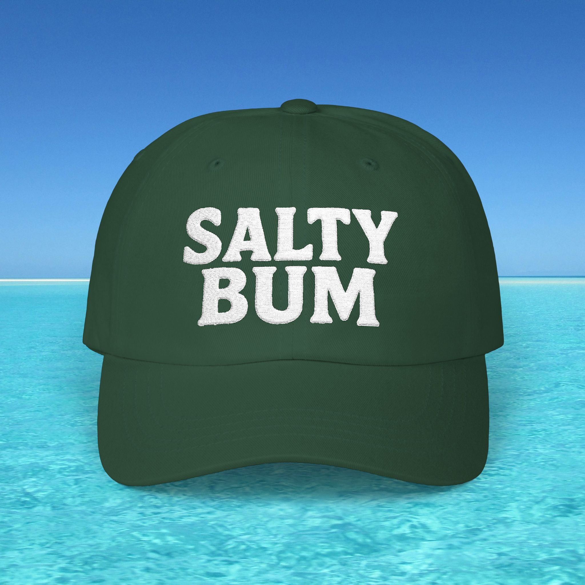 Green cap with 'Salty Bum' text on a blue water and sky background