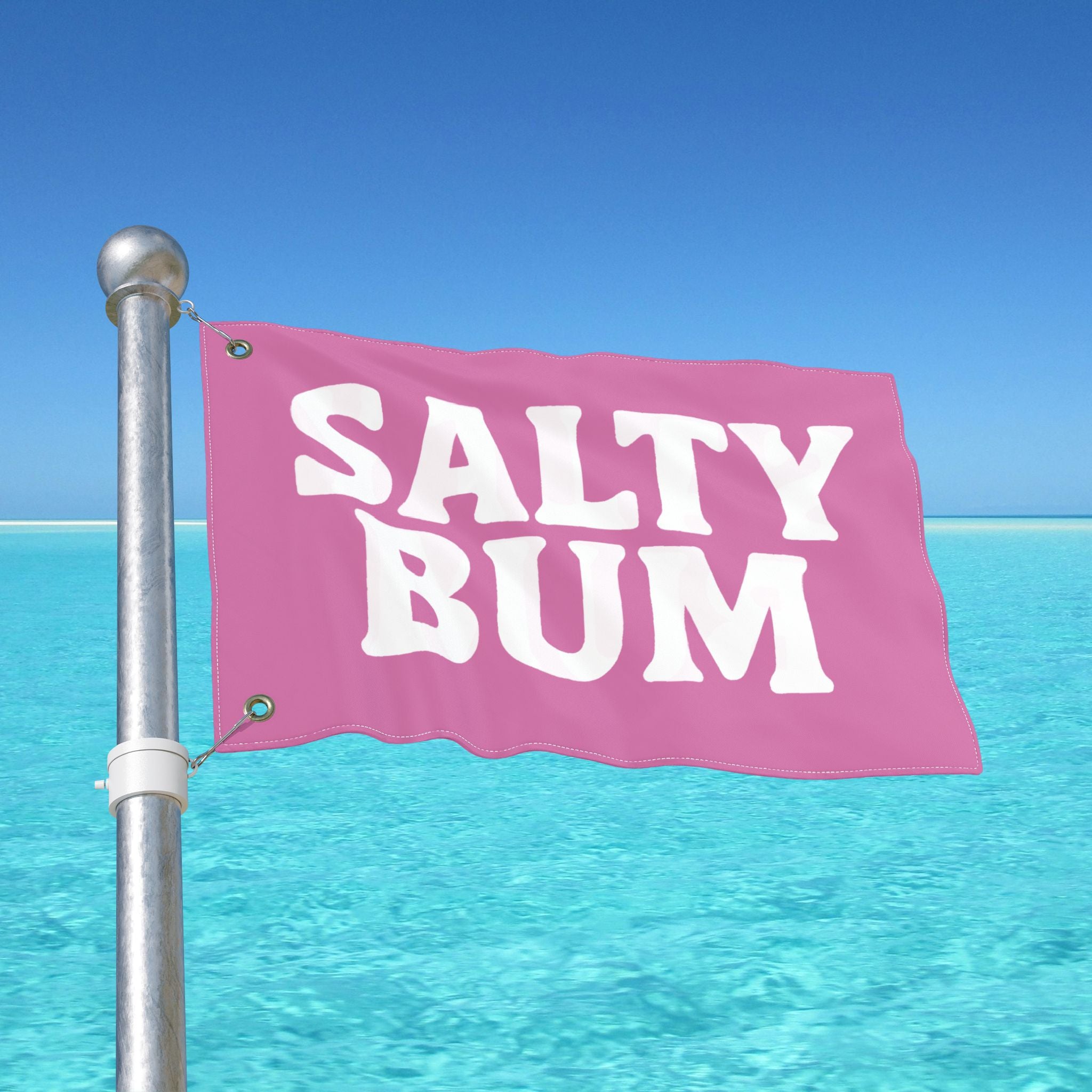 Pink flag with 'Salty Bum' text against a clear blue sky and ocean.