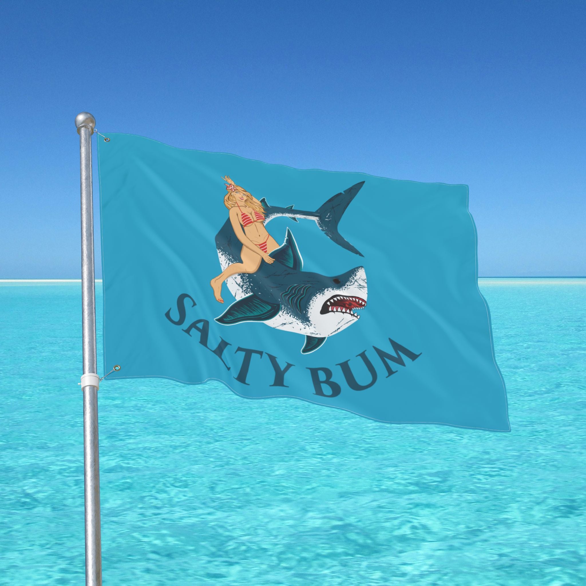 Flag with a shark and bikini-clad figure design against a blue ocean background