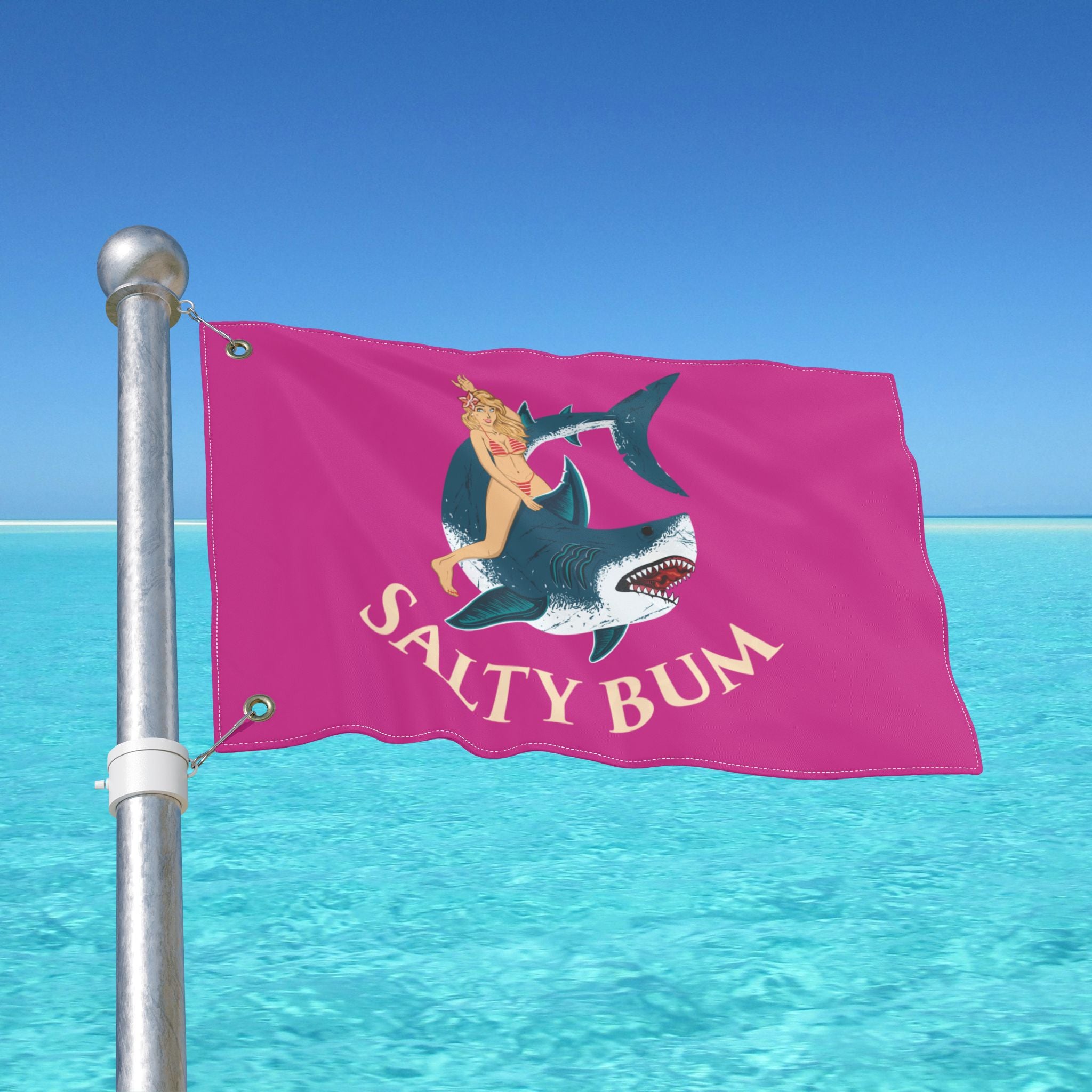 Flag with 'Salty Bum' design on a pole against a blue sky and ocean background