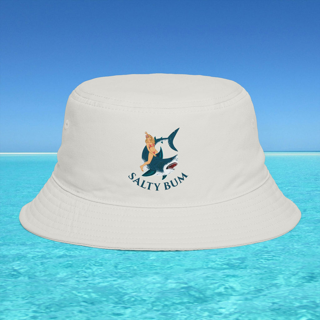 Beige bucket hat with 'Salty Bum' logo on a blue water and sky background