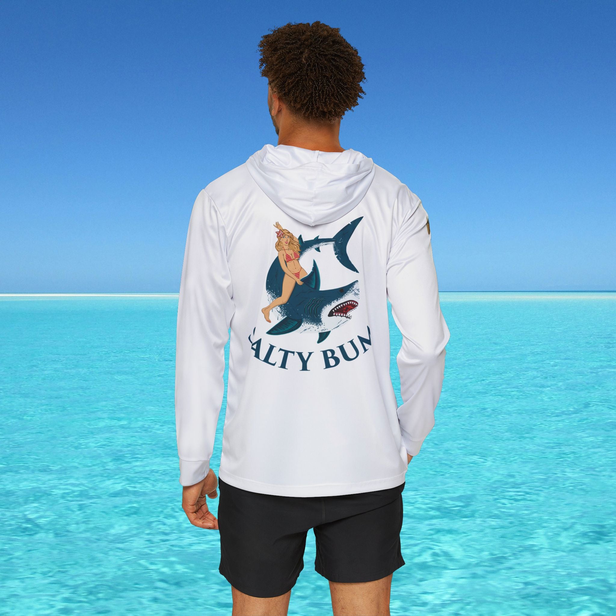 Person wearing a white hoodie with 'Salty Bun' logo in a beach setting