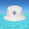 White bucket hat with 'Salty Bum' logo floating on clear blue water with a blue sky background