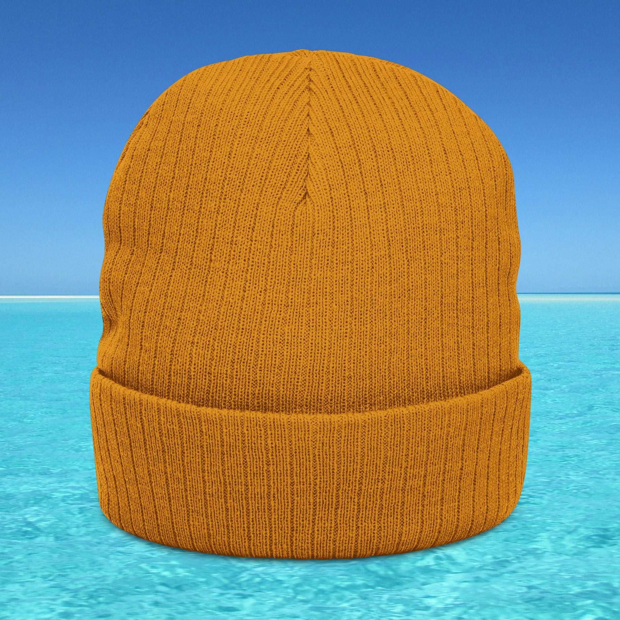 Orange knit beanie on a blue water background