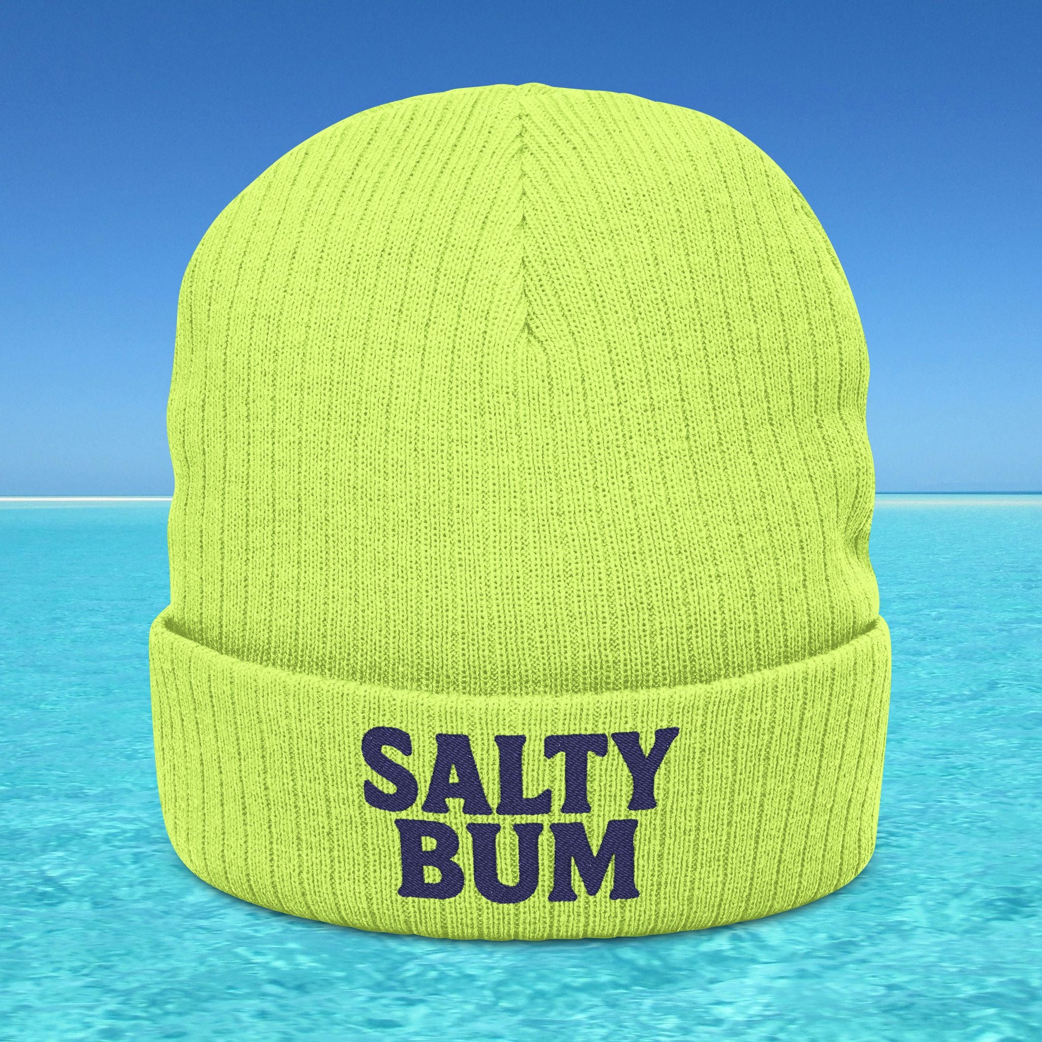 Green beanie with 'Salty Bum' text on a blue water background