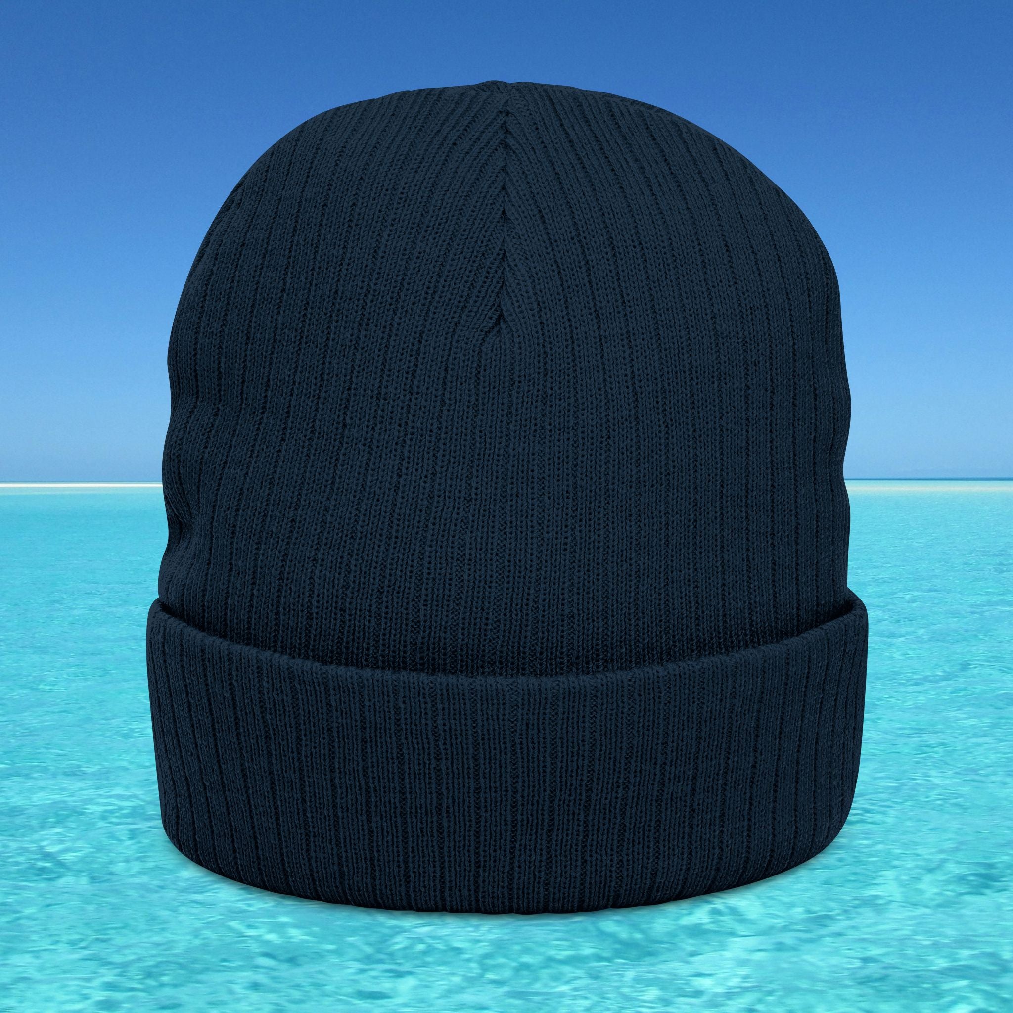 Black knit beanie on a blue and turquoise gradient background