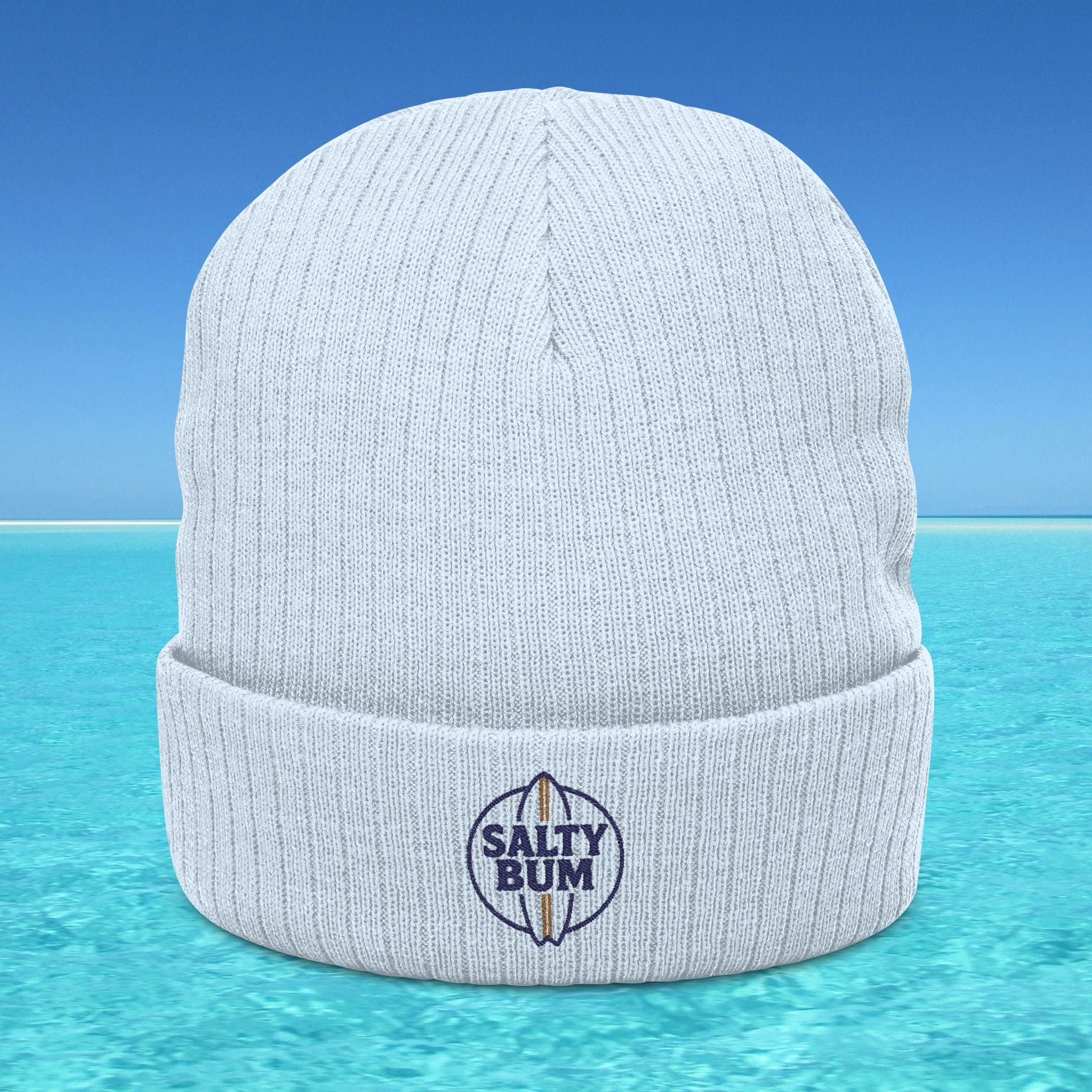 White beanie with 'Salty Bum' logo on a blue water background