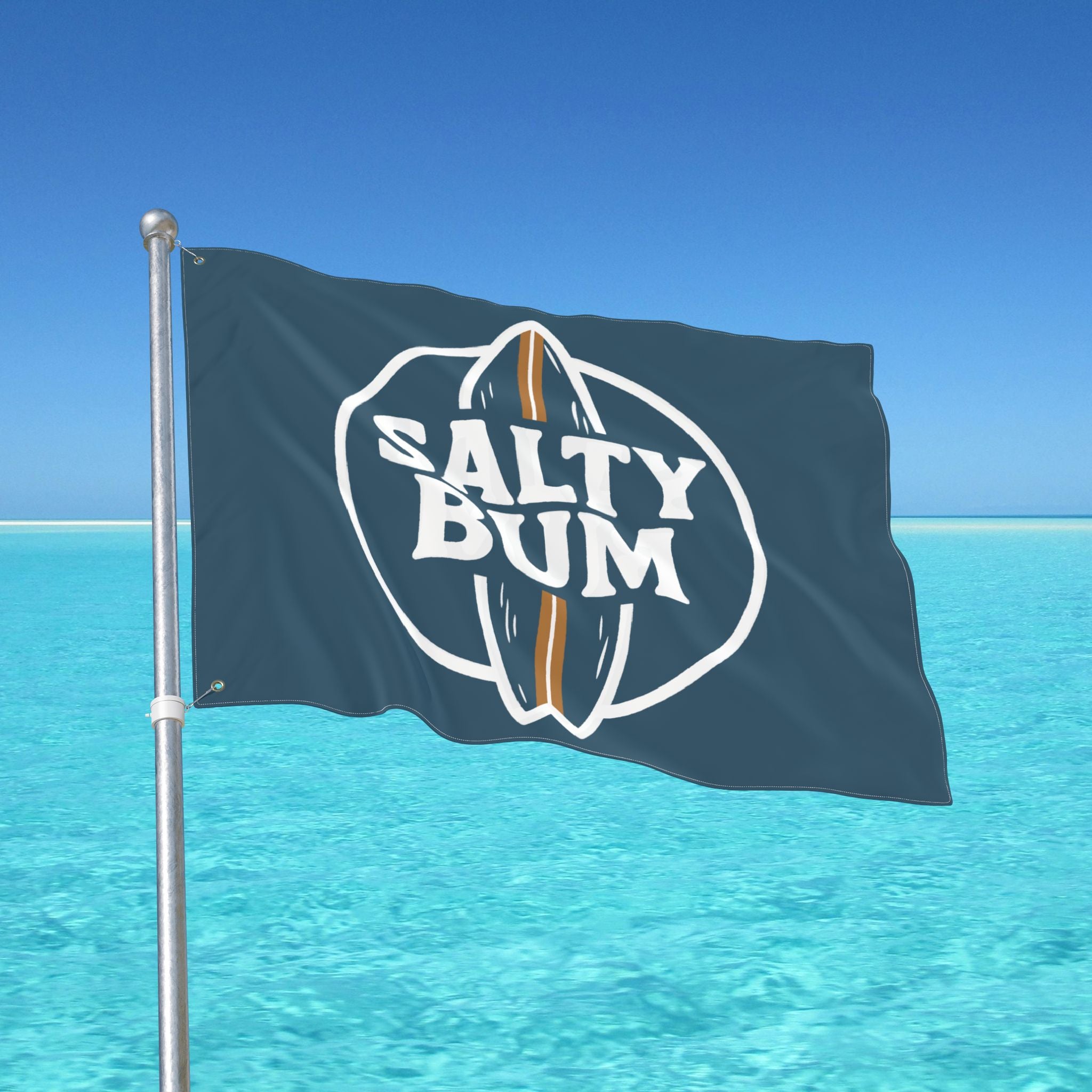 Flag with 'Salty Bum' logo waving in front of a clear blue sky and ocean.