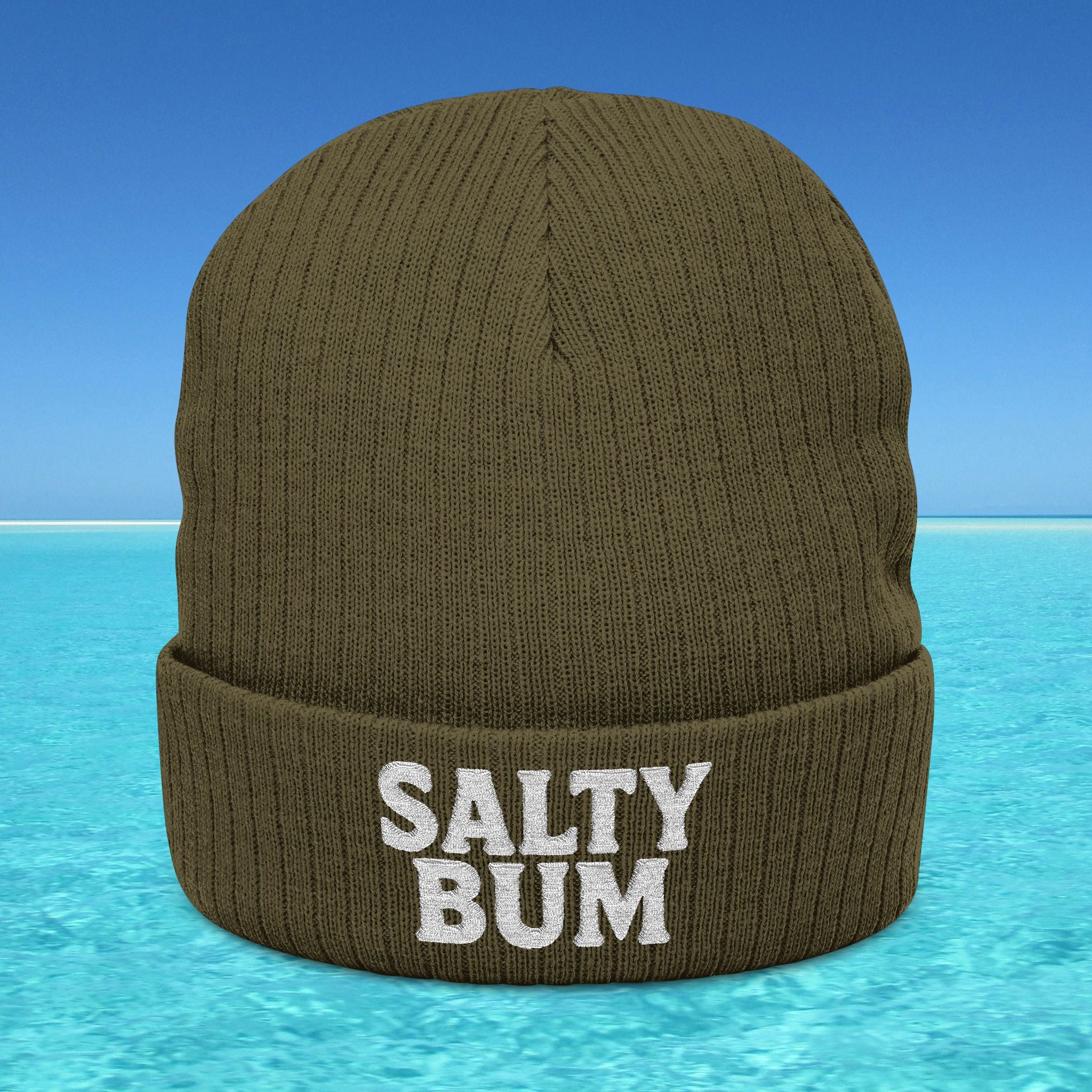 Brown beanie with 'Salty Bum' text on a blue water and sky background