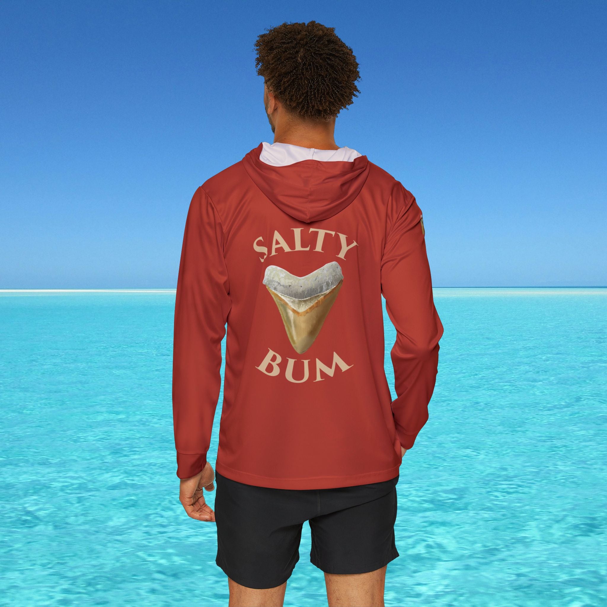 Person wearing a red hoodie with 'Salty Bum' text and ice cream graphic against a blue ocean background