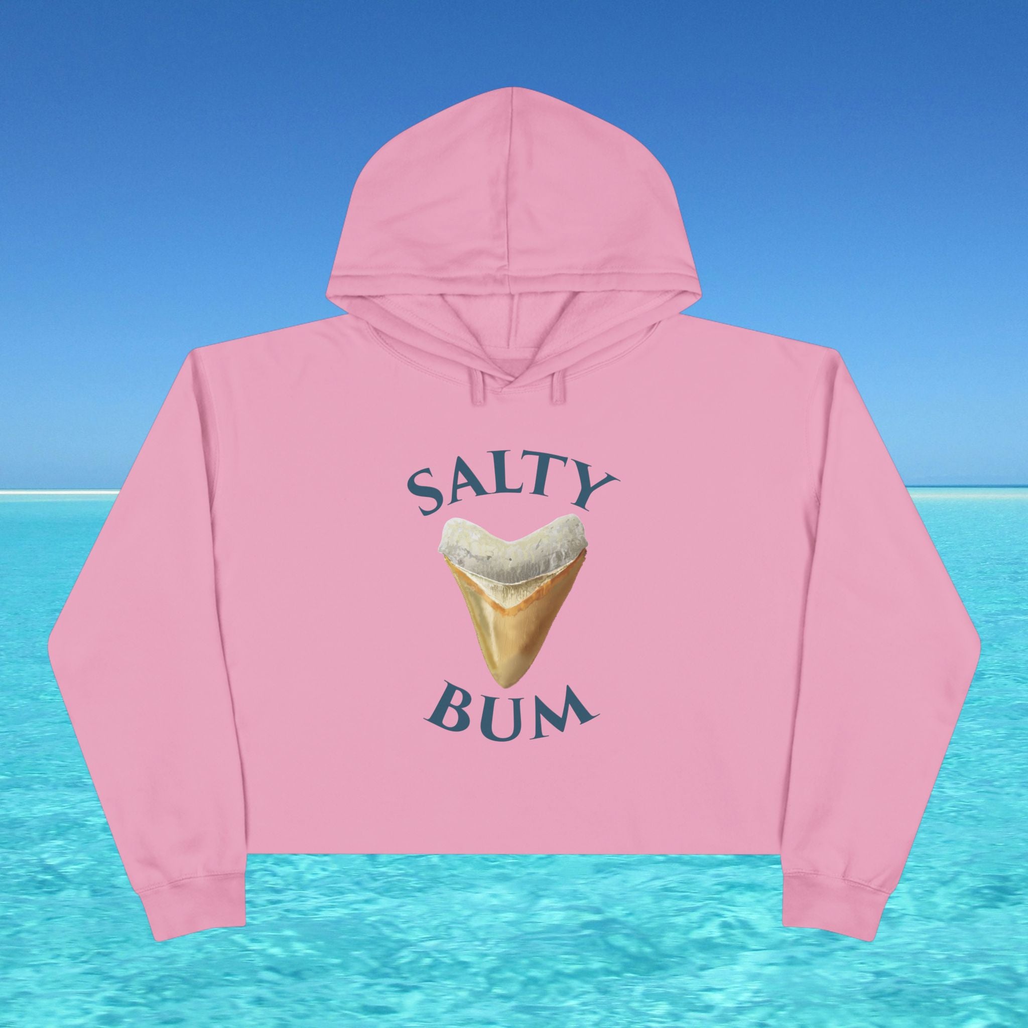 Pink hoodie with 'Salty Bum' graphic on a blue water and sky background