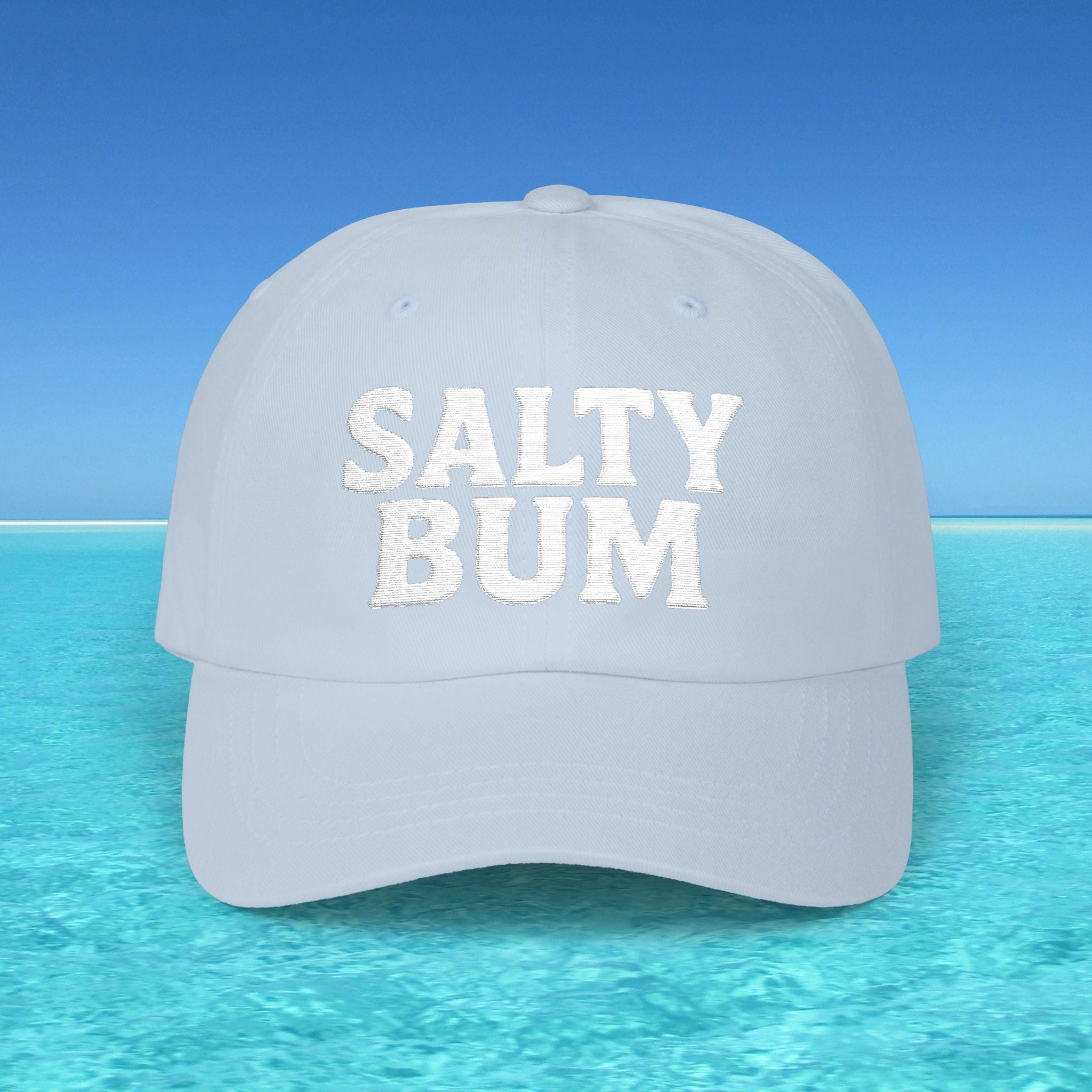 Light blue cap with 'SALTY BUM' text on a clear blue water background