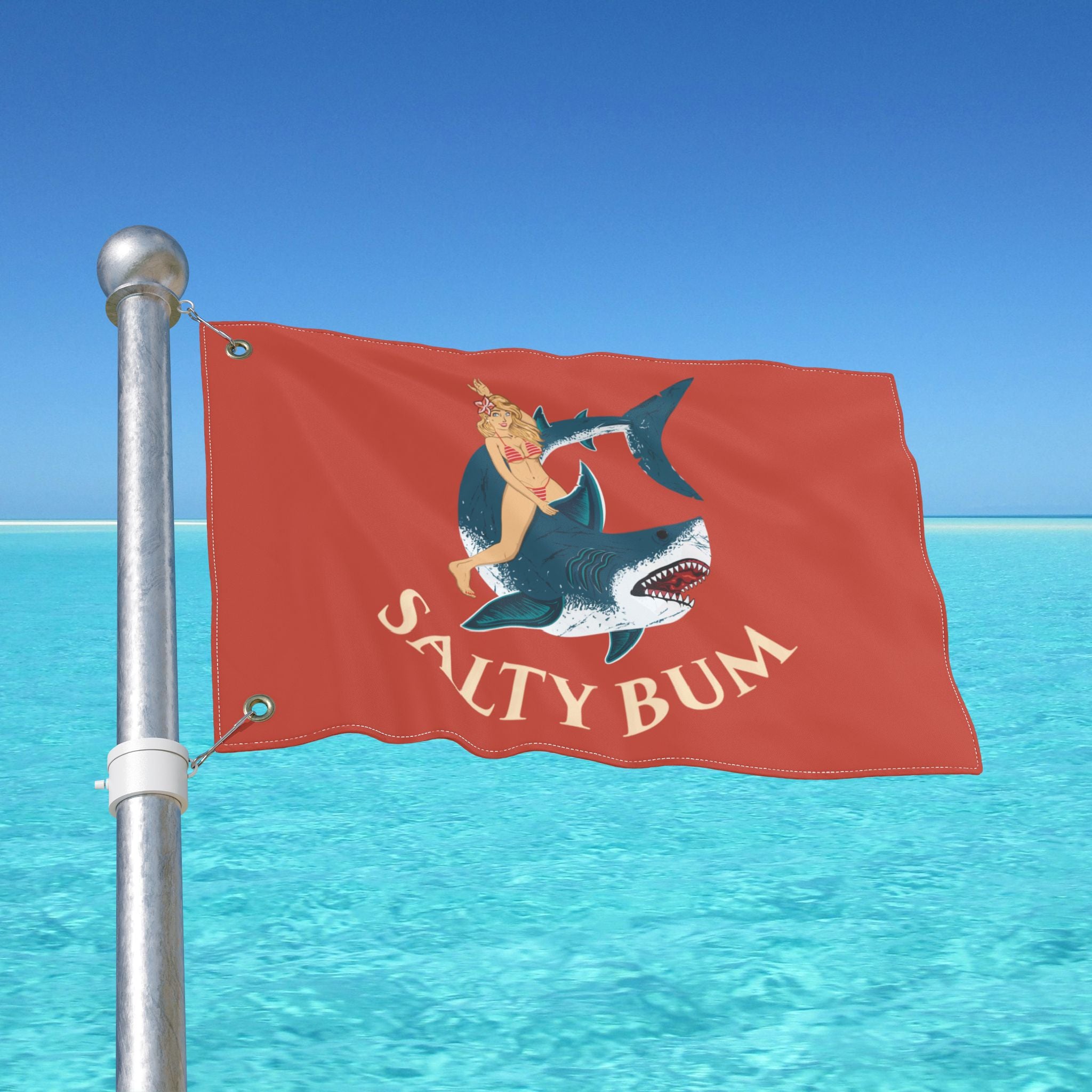 Flag with 'Salty Bum' design on a pole over clear blue water