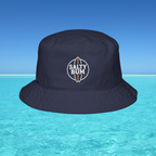 Navy bucket hat with 'Salty Bum' logo on a blue water and sky background