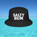 Black bucket hat with 'Salty Bum' text floating on water with a blue sky background