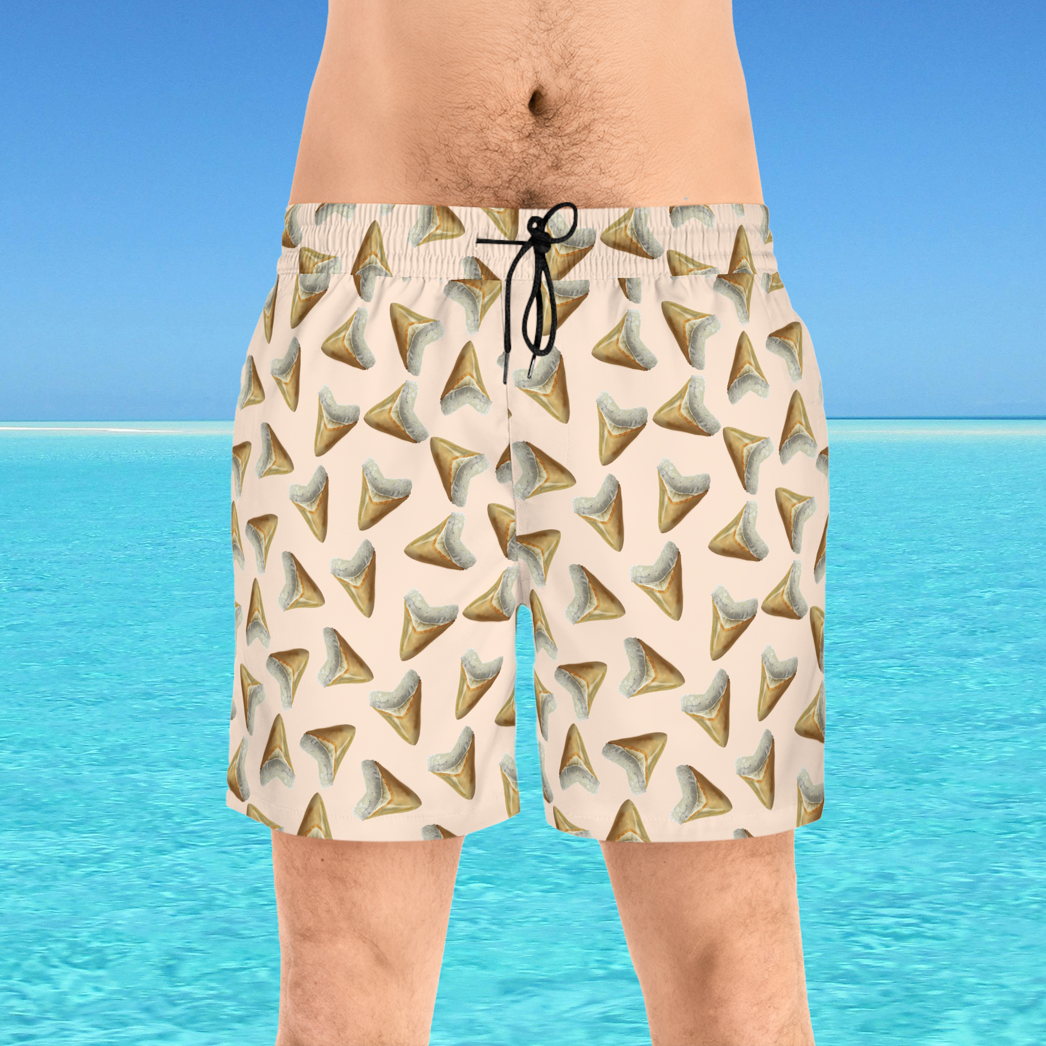 Beige shorts with shark tooth pattern worn by a person against a blue water and sky background