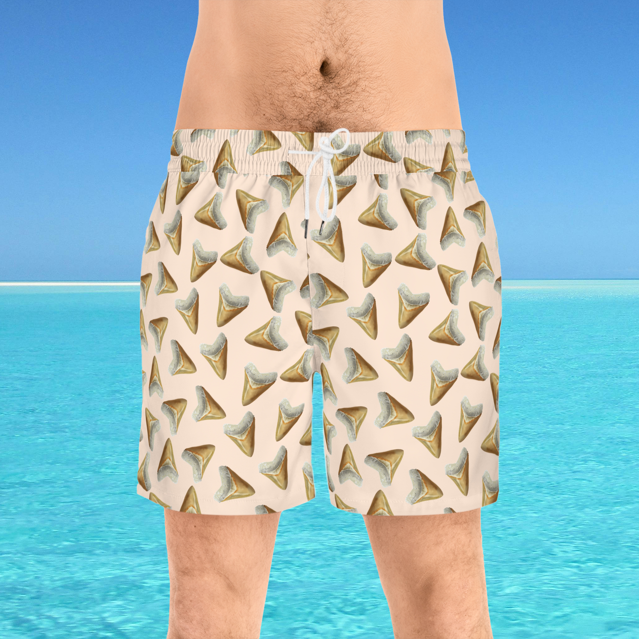 Beige shorts with shark tooth pattern worn by a person against a blue water and sky background