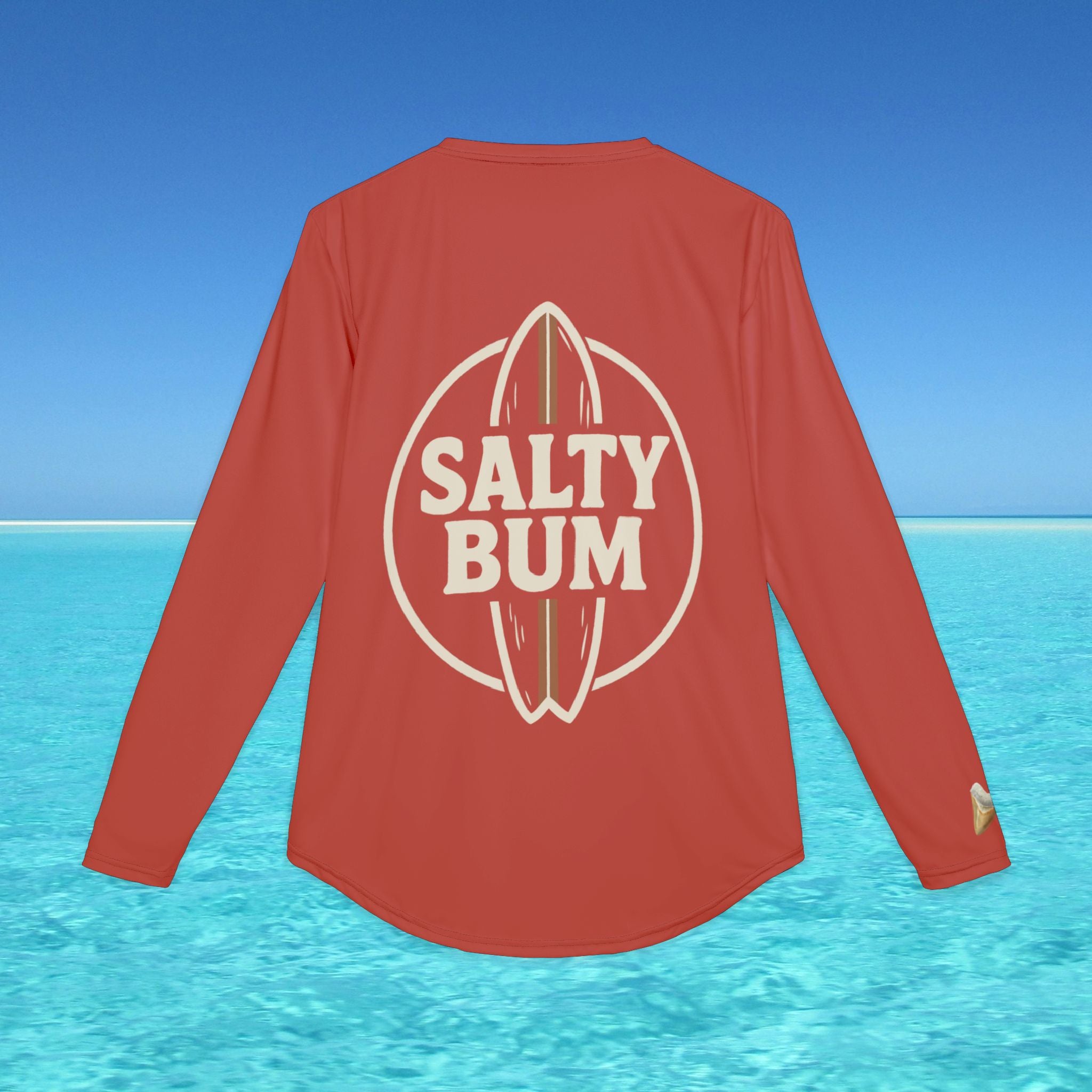 Red long-sleeve shirt with 'Salty Bum' logo on a blue water and sky background