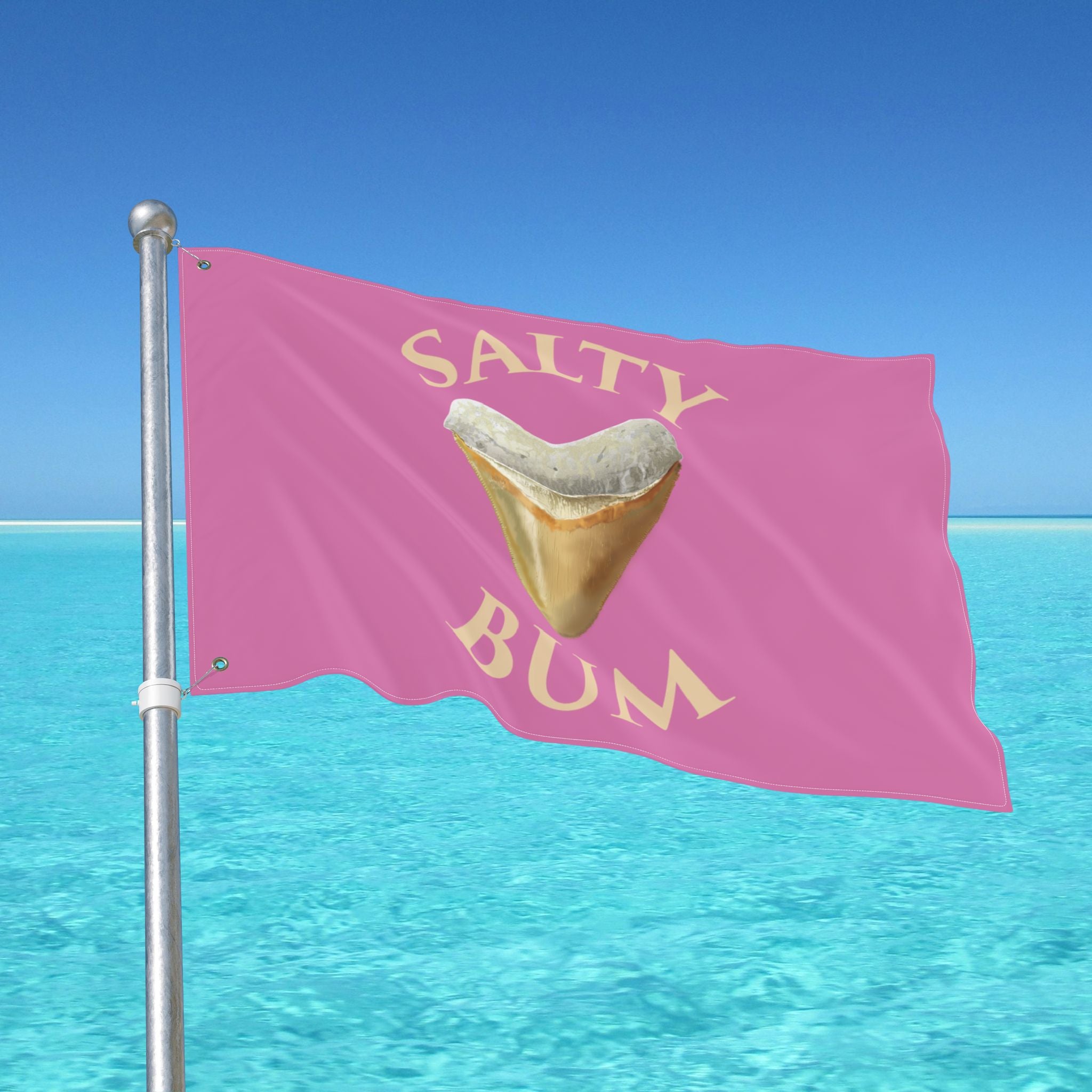 Pink flag with a shark tooth graphic and 'Salty Bum' text against a clear blue sky and ocean.