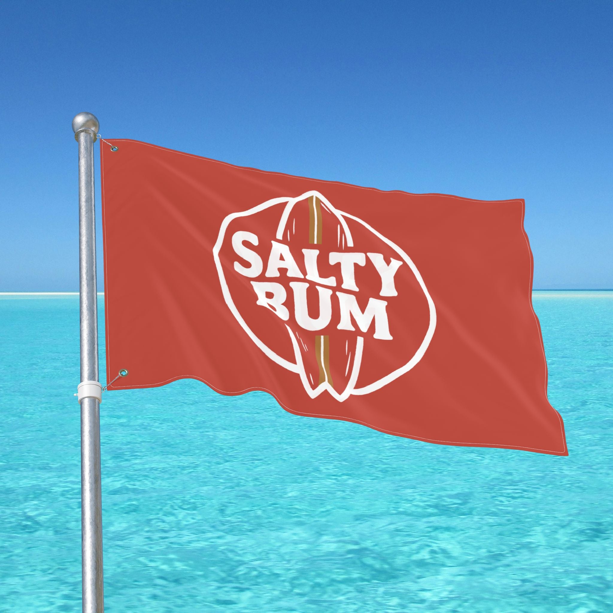 Red flag with 'Salty Rum' logo against a clear blue sky and ocean.