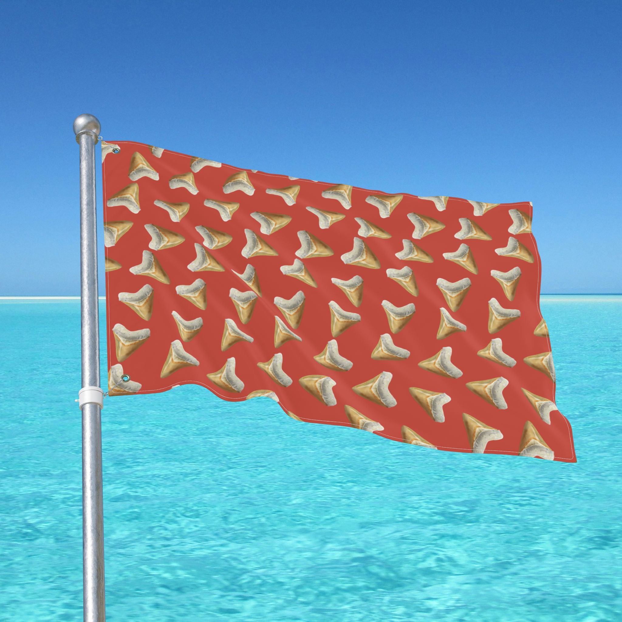 Red flag with tooth pattern against a blue sky and ocean background