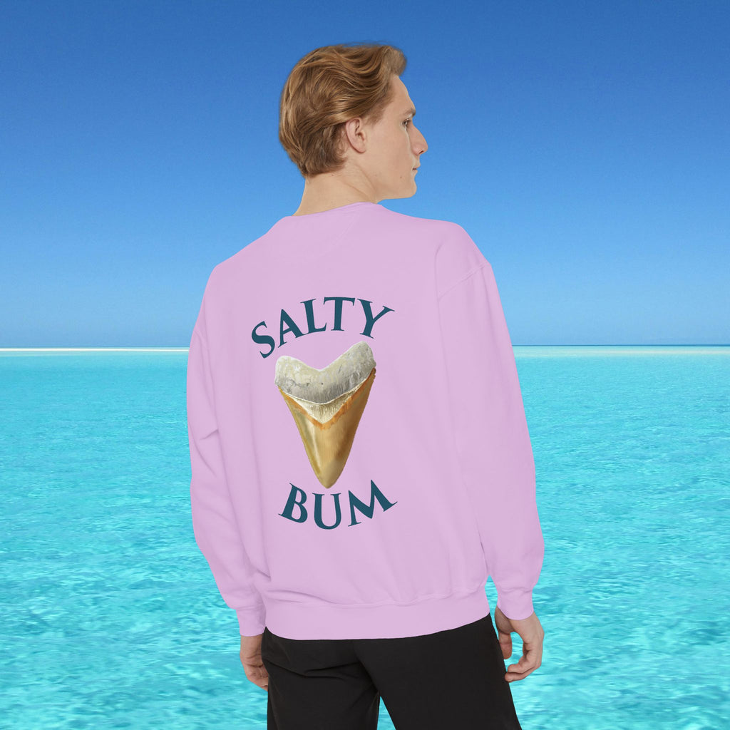 Person wearing a pink sweatshirt with 'Salty Bum' text and ice cream graphic, standing against a blue water and sky background.
