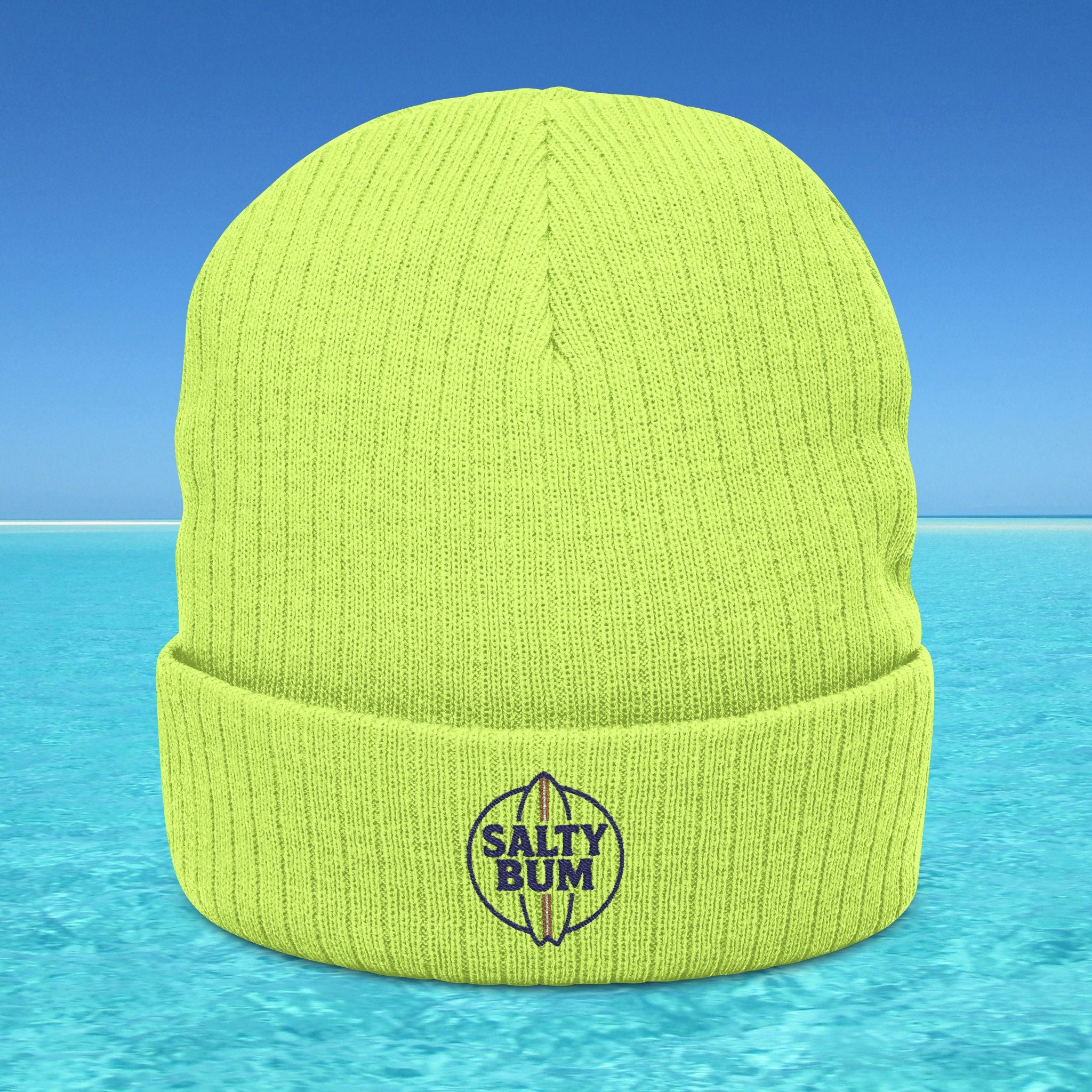 Green beanie with 'Salty Bum' logo on a blue water and sky background