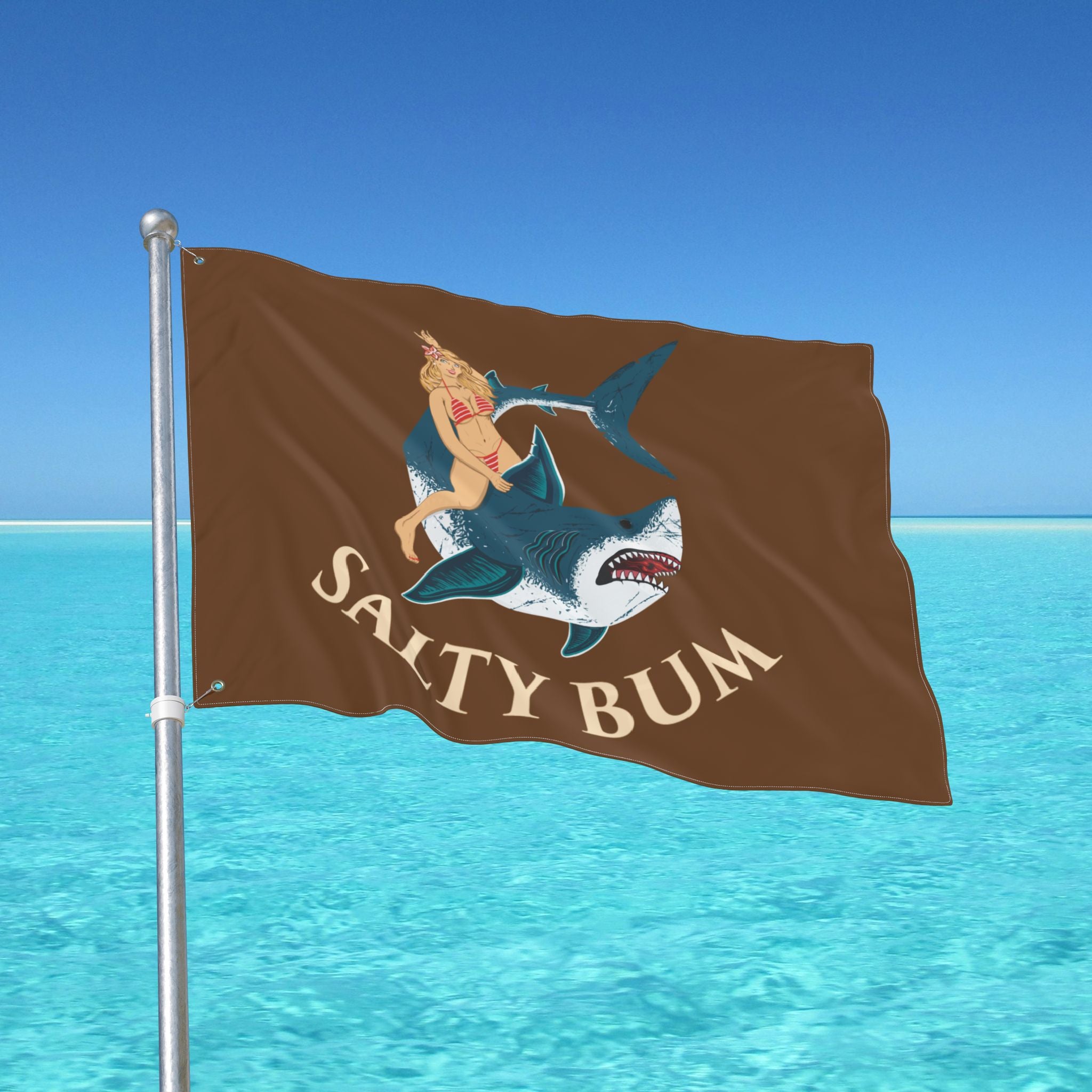 Flag with a shark and bikini-clad figure design against a blue ocean background