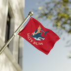 Red flag with 'Salty Bum' design on a pole against a blurred background