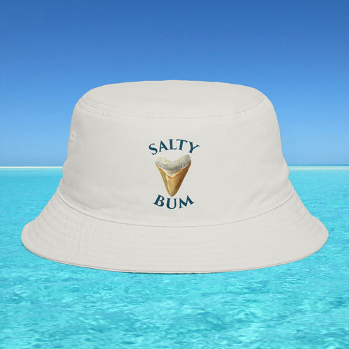 Beige bucket hat with 'Salty Bum' text and ice cream graphic on a blue water and sky background