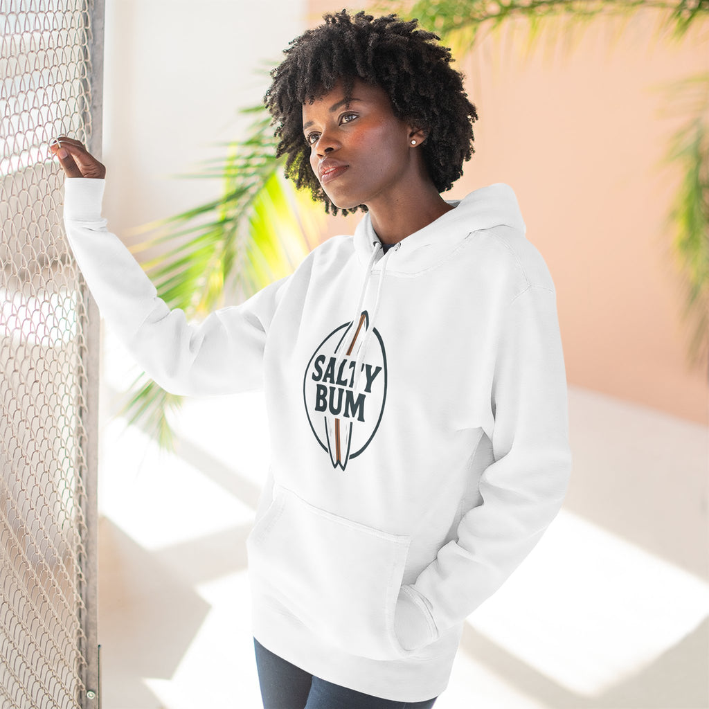 Person wearing a white hoodie with 'Salty Bum' logo, standing against a light background with plants.